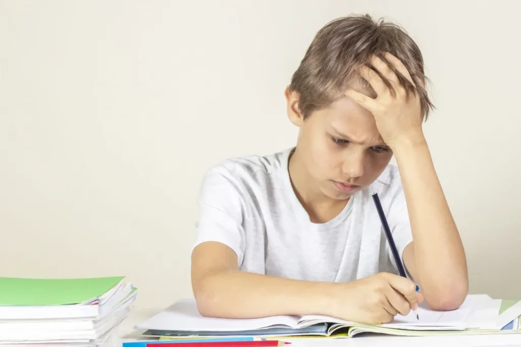 Boy doing homework frustrated